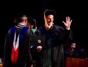 Doctor of Podiatric Medicine graduate Tommy Lee Talley receives his degree. (Jeff Malet, WesternU)