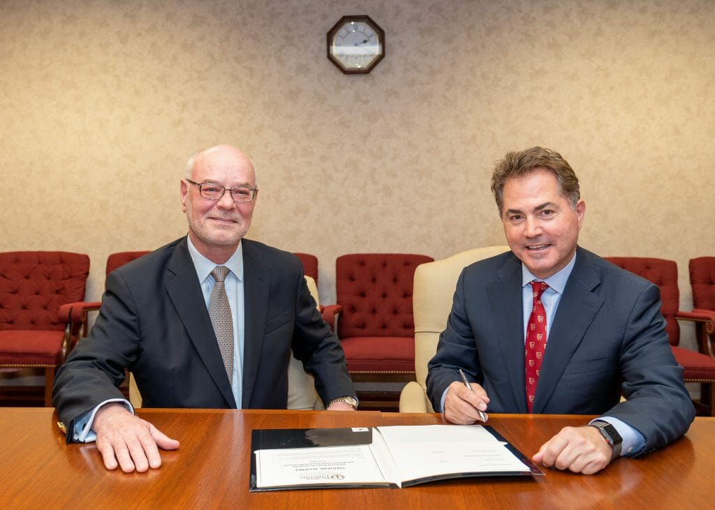 WesternU President Daniel R. Wilson, MD, PhD, left and CGU President Len Jessup, PhD, sign a memorandum of understanding (MOU) Tuesday, June 4, 2019 forming a strategic alliance