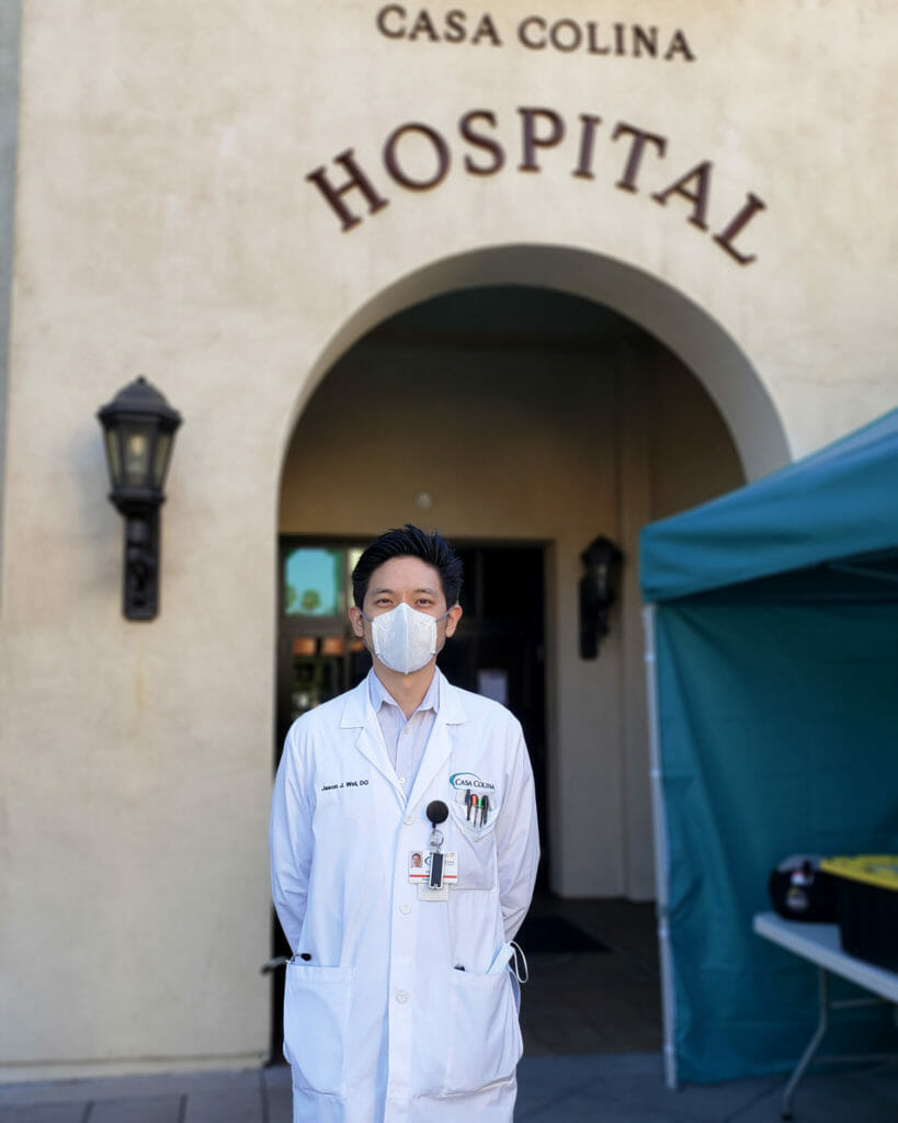 Osteopathic doctor wearing a white coat and N95 mask.