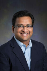 Head shot of Dr. Harsha Deoghare, wearing a sport coat.