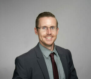 Head shot of Joshua McFarlen wearing a suit and tie.