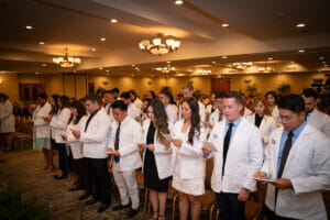 CPM incoming students taking the Oath for the first time.