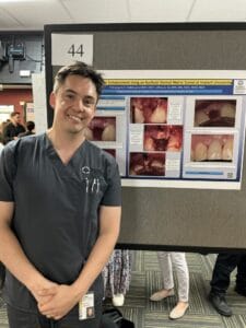 A man standing in front of a poster.