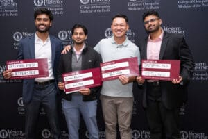 Four men stand in front of a Western University of Health Sciences backdrop, each holding signs showing their medical residency matches in various internal medicine programs.